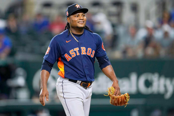 Houston Astros’ Framber Valdez smiles as he walks to the dugout after working against the Texas Rangers during the eighth inning of a baseball game in Arlington, Texas, Tuesday, Aug. 30, 2022.